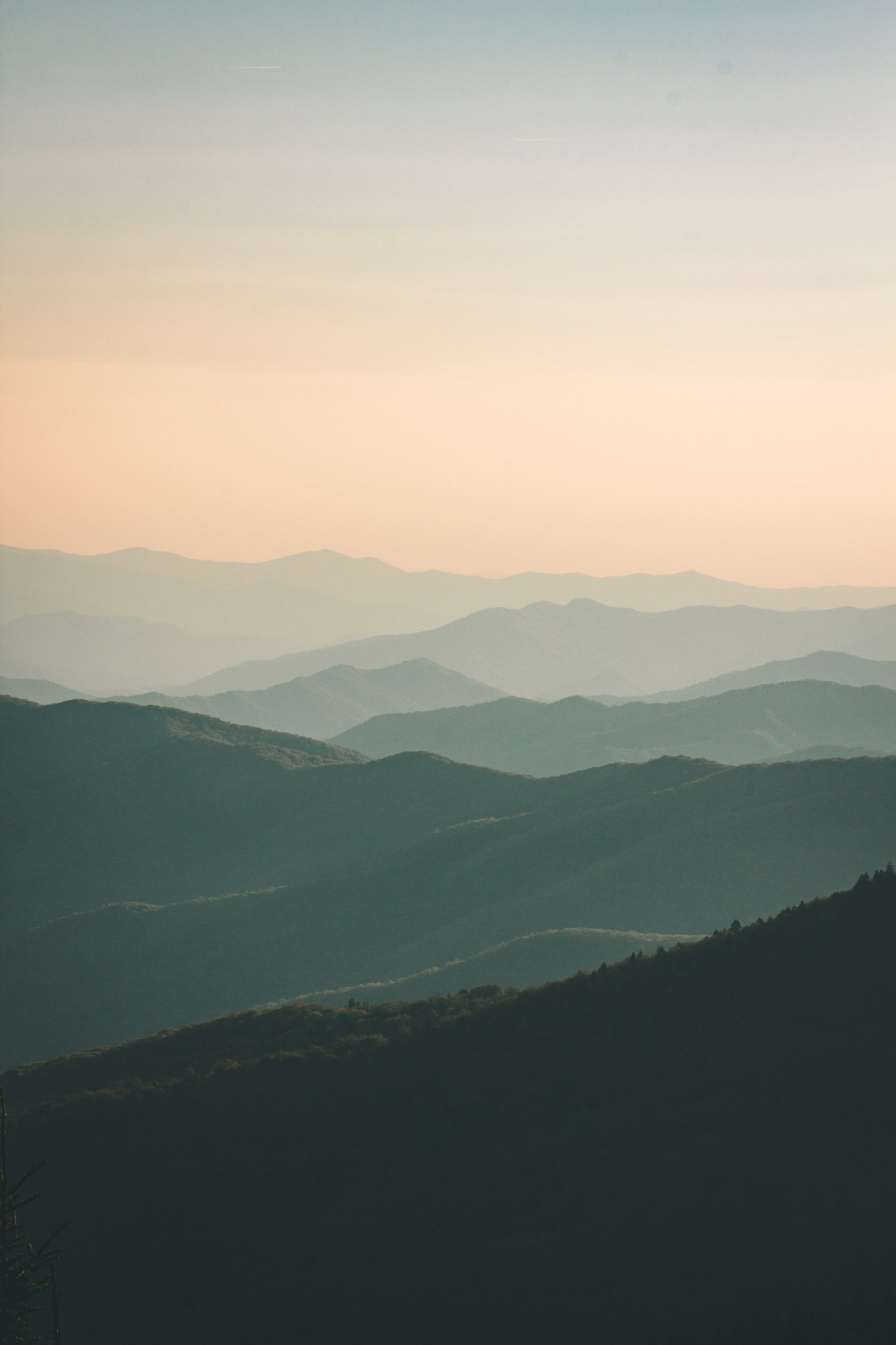 Layer after layer of blue-green mountain ridges fading into haze.